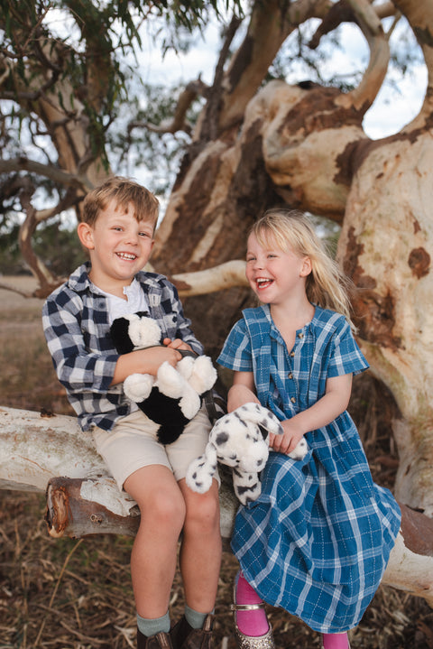 A soft plush dog toy with a charming personality and refined style. Perfect for babies, kids, and comforting cuddles.