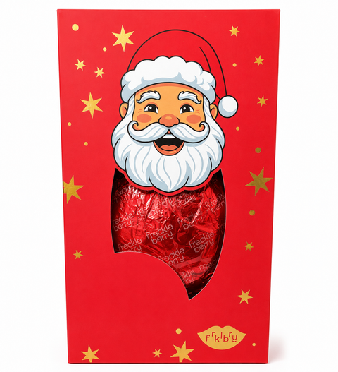 A festive red gift box featuring a cartoon Santa Claus face with a white beard and hat, with a die-cut window showing a large red wrapped chocolate inside. The box is decorated with gold stars and the brand name 'FōkŽu' at the bottom.