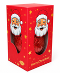 A red Christmas-themed gift box with Santa Claus illustrations and gold star accents, showing two red-wrapped chocolate eggs through oval cutouts. The box has 'Merry Christmas!' printed on the front and a small 'MADE IN UK' label near the bottom.