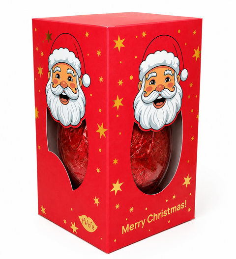 A red Christmas-themed gift box with Santa Claus illustrations and gold star accents, showing two red-wrapped chocolate eggs through oval cutouts. The box has 'Merry Christmas!' printed on the front and a small 'MADE IN UK' label near the bottom.