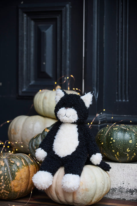 A playful black and white farm feline with a mischievous streak - soft plush toys for kids.