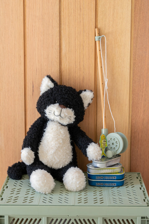 A playful black and white farm feline with a mischievous streak - soft plush toys for kids.