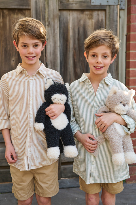 A playful black and white farm feline with a mischievous streak - soft plush toys for kids.