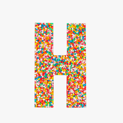 Premium Belgian chocolate letter "H" topped with colourful sprinkles – a fun and tasty treat perfect for personalising any occasion.