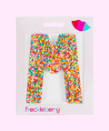 Premium Belgian chocolate letter "M" topped with colourful sprinkles – a fun and tasty treat perfect for personalising any occasion.