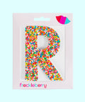 Premium Belgian chocolate letter "R" topped with colourful sprinkles – a fun and tasty treat perfect for personalising any occasion.