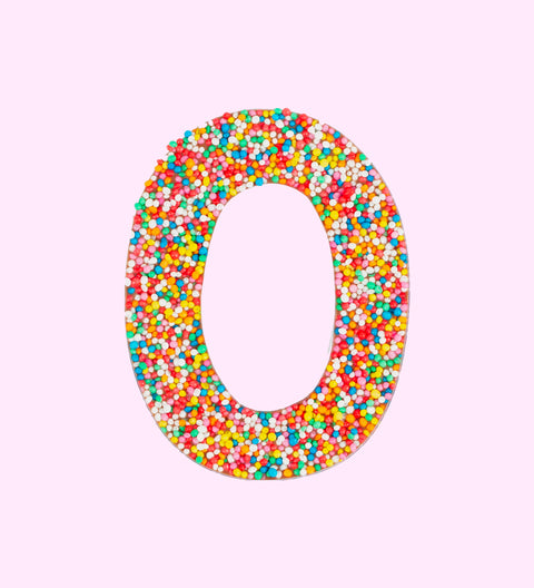 Belgian milk chocolate number 0 covered with multicolored sprinkles, shaped as a number zero.