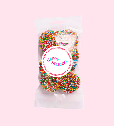 Dark chocolate freckles made from rich premium Belgian dark chocolate and topped with colourful sprinkles with Happy Holidays stickers. A festive treat perfect for gifting or sharing.