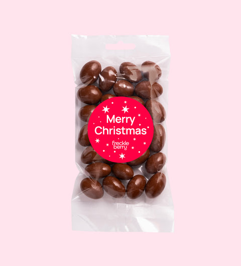Crunchy roasted almonds covered in smooth Belgian milk chocolate wrapped in festive "Merry Christmas - Stars" label/design, perfect for festive gifting or snacking.