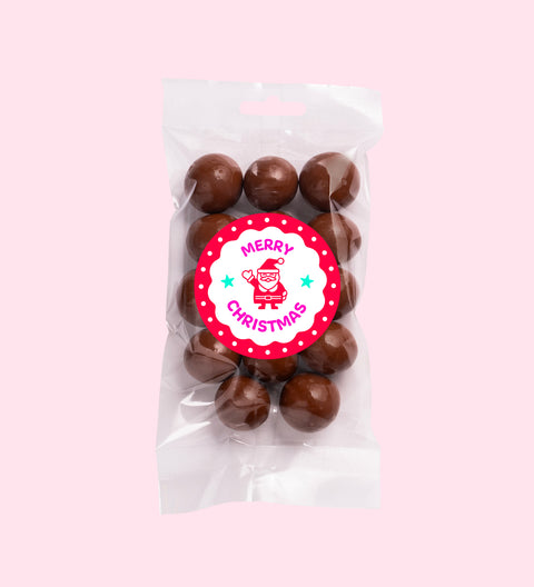 Crunchy macadamias coated in smooth Belgian milk chocolate with "Merry Christmas - Santa" label/design, perfect for festive gifting and snacking.