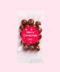 Tangy raspberries covered in smooth premium Belgian milk chocolate  with Merry Christmas - Stars sticker/label – a decadent festive treat.