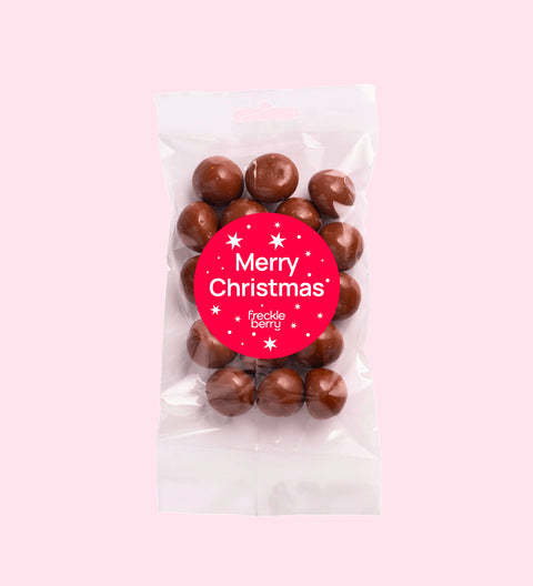 Tangy raspberries covered in smooth premium Belgian milk chocolate  with Merry Christmas - Stars sticker/label – a decadent festive treat.