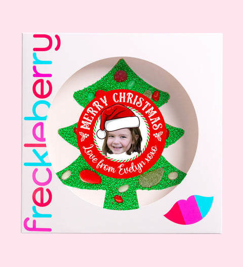 Premium Belgian chocolate tree (available in 3 variants - dark, milk or white) topped with colourful lollies and vibrant green sprinkles, customised with a festive Santa hat design for holiday cheer.