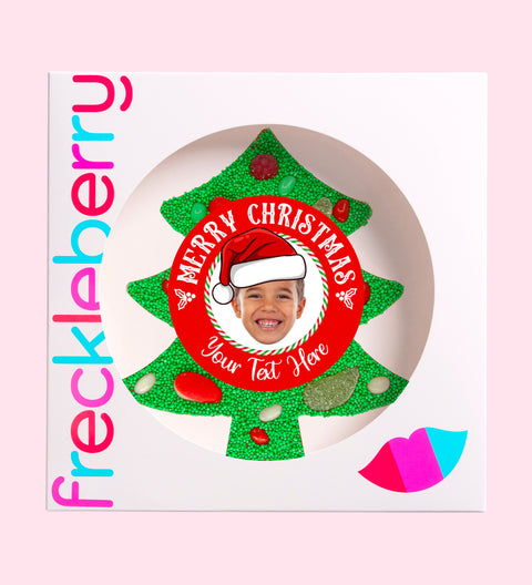 Premium Belgian chocolate tree (available in 3 variants - dark, milk or white) topped with colourful lollies and vibrant green sprinkles, customised with a festive Santa hat design for holiday cheer.