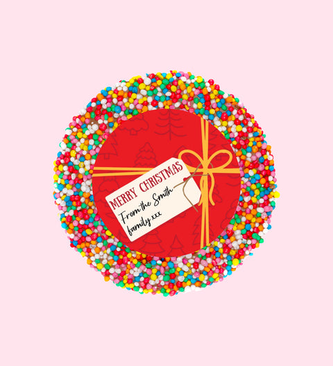 Creamy Belgian chocolate (available in 3 variants - dark, milk or white) topped with colourful sprinkles, customised with a festive red present design for holiday gifting.