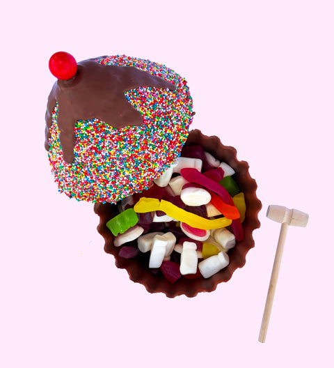 Fun, edible Belgian chocolate cake designed to be smashed and shared, perfect for celebrations and memorable moments. Includes 450g party bag of lollies or raspberries for filling. 
