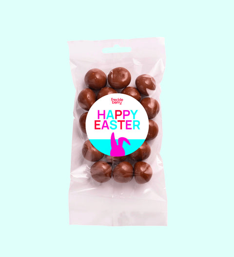 Tangy raspberries covered in smooth premium Belgian milk chocolate with Happy Easter - Bunny sticker, a decadent and fruity festive treat.