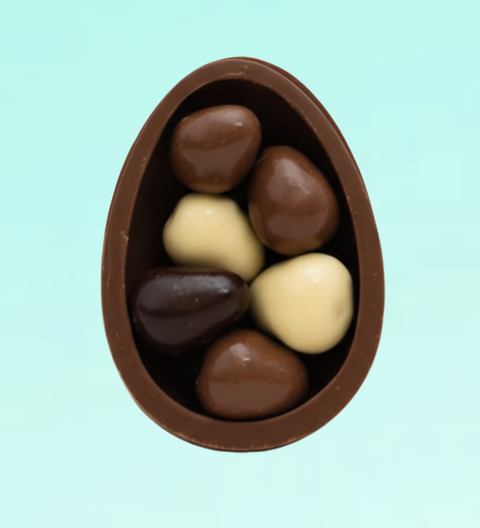 Half easter egg filled with white, milk and dark chocolate freeze-dried strawberries in a pink box - perfect for Easter celebrations.