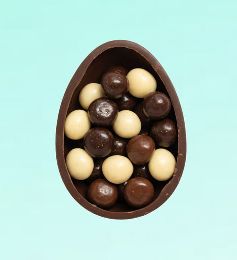 Half Easter egg filled with white, milk and dark chocolate-coated raspberries - a rich, fruity and elegant Easter treat made for gifting and sharing.
