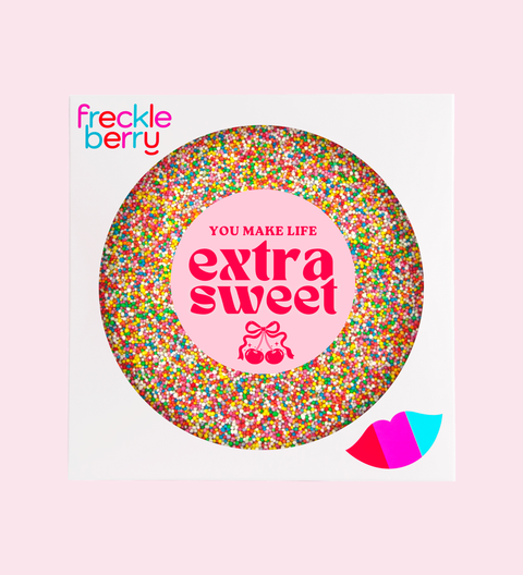 Chocolate Freckleberry product with colorful sprinkles and 'You Make Life Extra Sweet' text on a pink background
