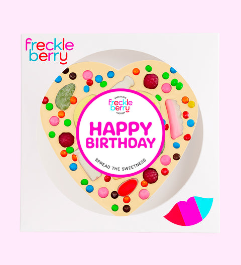 Giant heart-shaped Belgian white chocolate pizza loaded with colourful lollies, the perfect festive treat to celebrate birthdays.