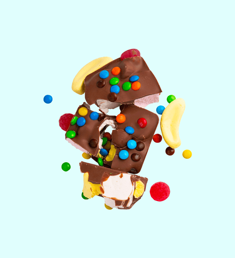 Fun Rocky Road bursting with marshmallows, nuts, and colourful candies, all coated in smooth premium Belgian milk chocolate – a playful and delicious treat.
