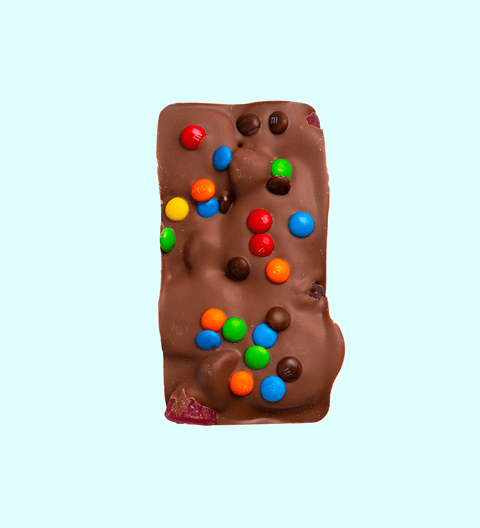 Fun Rocky Road bursting with marshmallows, nuts, and colourful candies, all coated in smooth premium Belgian milk chocolate – a playful and delicious treat.