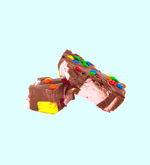 Fun Rocky Road bursting with marshmallows, nuts, and colourful candies, all coated in smooth premium Belgian milk chocolate – a playful and delicious treat.