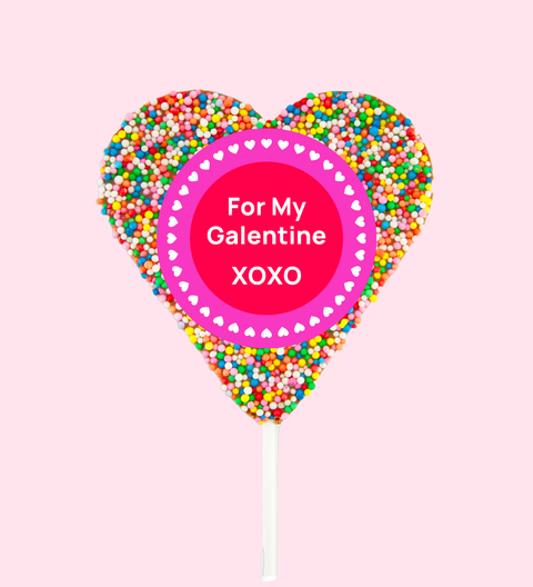 Creamy Belgian chocolate heart covered in vibrant multi sprinkles, wrapped in a cheerful For My Galentine XOXO design/label - the perfect sweet gift to say “I love you".
