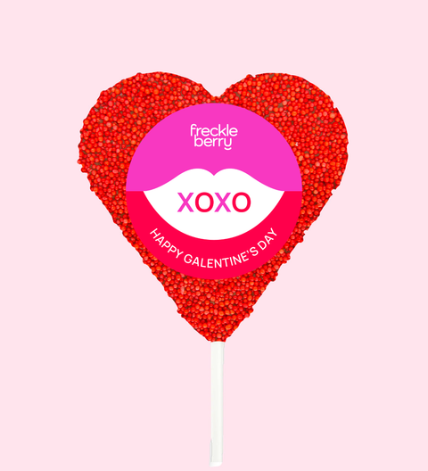 Creamy Belgian chocolate heart covered in vibrant red sprinkles, wrapped in a cheerful XOXO design/label - the perfect sweet gift to say “I love you".