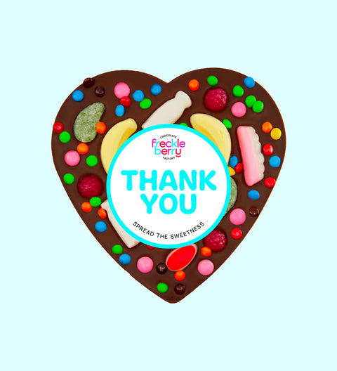 Giant heart-shaped Belgian dark chocolate pizza loaded with colourful lollies, personalised with 100mm Thank You sticker, a fun and sweet way to say thanks.