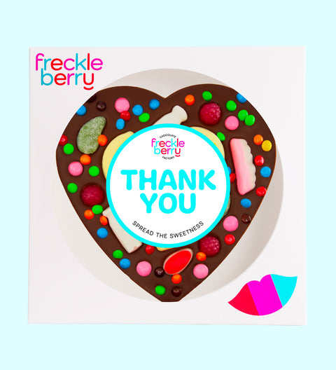 Giant heart-shaped Belgian dark chocolate pizza loaded with colourful lollies, personalised with 100mm Thank You sticker, a fun and sweet way to say thanks.