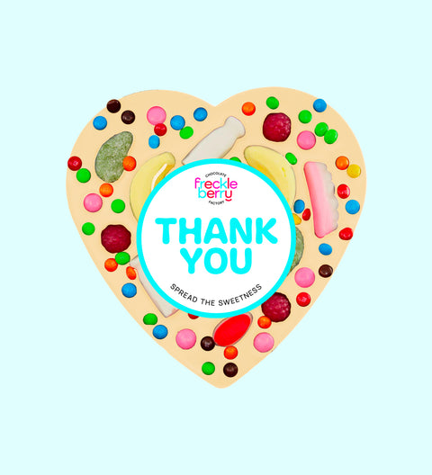 Giant heart-shaped Belgian white chocolate pizza loaded with colourful lollies, personalised with 100mm Thank You sticker, a fun and sweet way to say thanks.