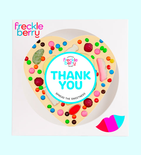Giant heart-shaped Belgian white chocolate pizza loaded with colourful lollies, personalised with 100mm Thank You sticker, a fun and sweet way to say thanks.