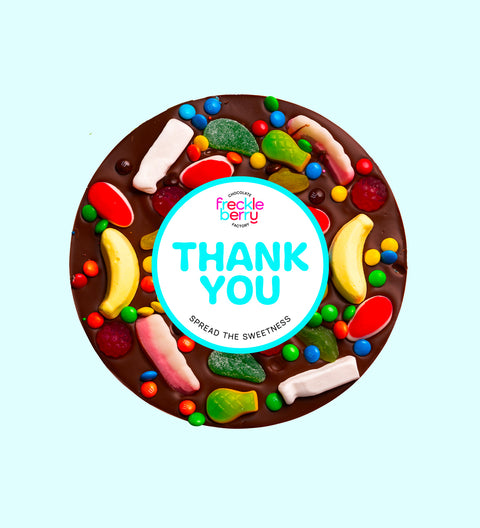Giant Belgian dark chocolate pizza loaded with colourful lollies, personalised with 100mm Thank You sticker, a fun and sweet way to say thanks.