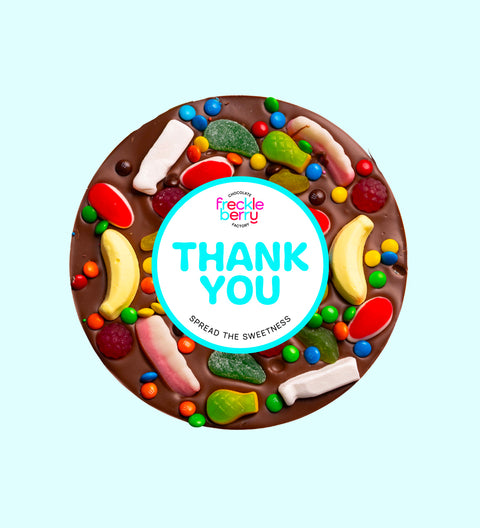 Giant Belgian milk chocolate pizza loaded with colourful lollies, personalised with 100mm Thank You sticker, a fun and sweet way to say thanks.