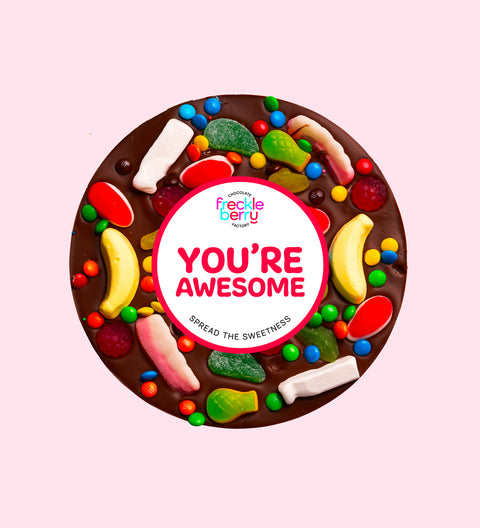 Premium Belgian dark chocolate pizza loaded with colourful lollies with "You're Awesome" design/label, a fun and sweet way to celebrate someone special.