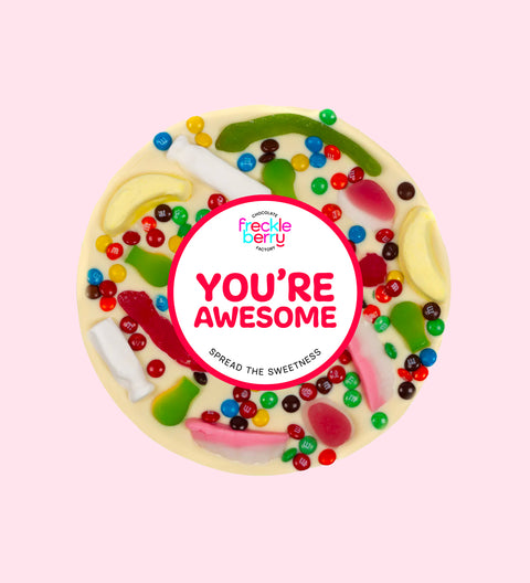 Premium Belgian white chocolate pizza loaded with colourful lollies with "You're Awesome" design/label, a fun and sweet way to celebrate someone special.