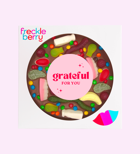 Freckleberry chocolate bar with colorful candy pieces and 'grateful for you' text on a white background