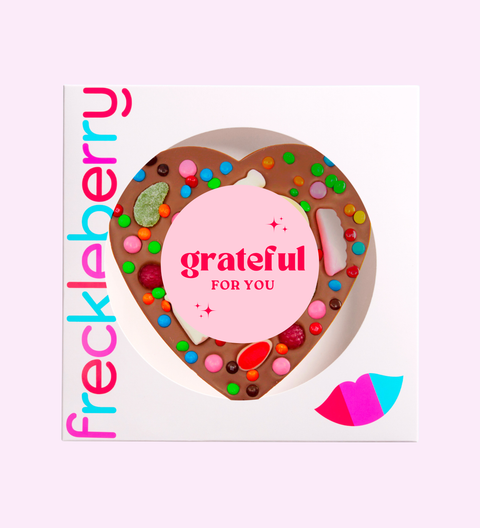 Frecklaberry product with colorful toppings and 'grateful for you' text on a pink background