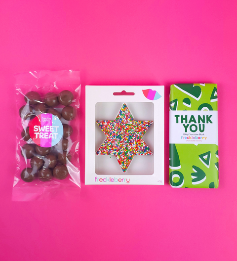 Belgian chocolate trio with handcrafted shape, Happy Birthday block & raspberries — beautifully wrapped & ready to gift.