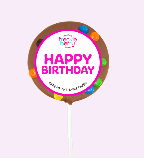 Freckle Berry birthday cake topper with colorful sprinkles on a white background