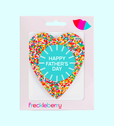A heart-shaped chocolate with 'HAPPY FATHER'S DAY' written in the center, surrounded by colorful sprinkles. The product is packaged in a box with the brand name 'freckleberry' at the bottom.