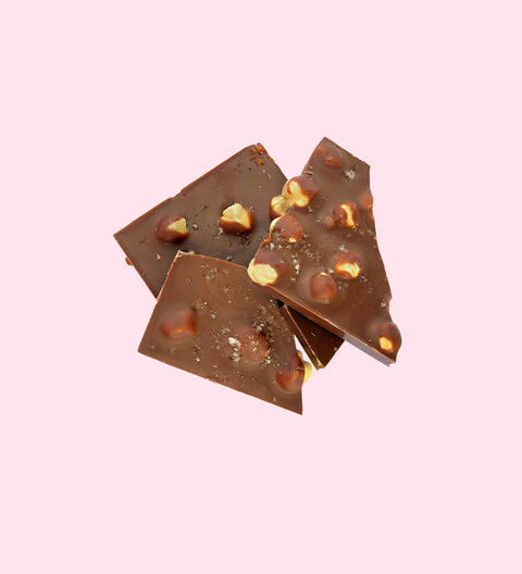 Creamy Belgian milk chocolate heart filled with roasted hazelnuts, gooey caramel, and a sprinkle of sea salt for the perfect indulgence - in pieces