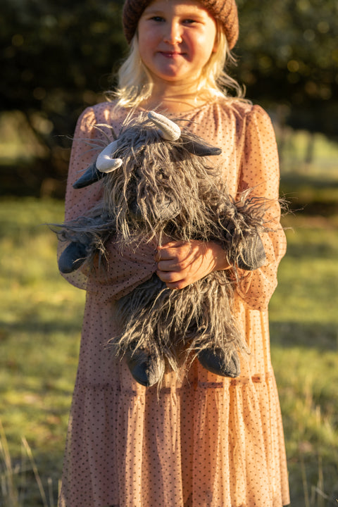 Young girl holding Henry the highland cow - cute stuffed cow makes the ideal gift or comforting companion. Great for any house, decoration or stylist. 
