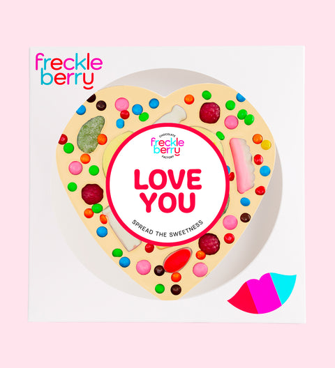 Premium giant Belgian white chocolate heart pizza loaded with colourful lollies and M&M®s with "Love You" sticker/design - perfect to express love in all occasions. 