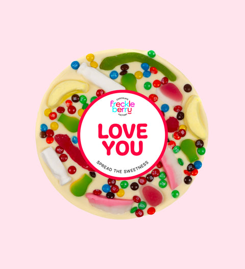 Premium giant Belgian white chocolate pizza loaded with colourful lollies and M&M®s with "Love You" sticker/design - perfect to express love in all occasions. 