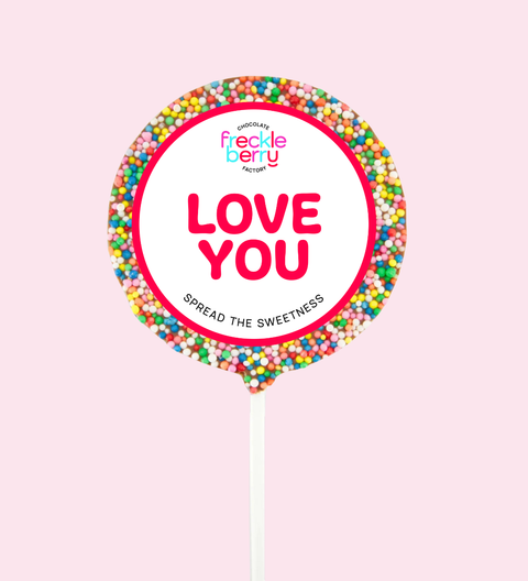 Fruit roll-up with 'Love You' message and Freckle Berry logo on a pink background