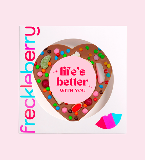 Heart-shaped chocolate with colorful toppings and 'life's better with you' message, branded 'frecklaberry'.