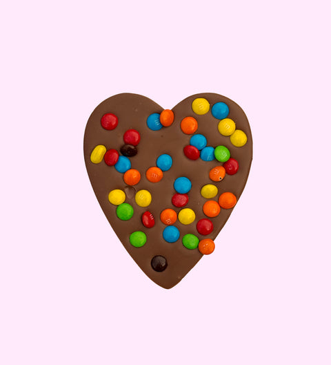 Creamy Belgian milk chocolate heart topped with colourful M&M® s, perfect for gifting or treating yourself.